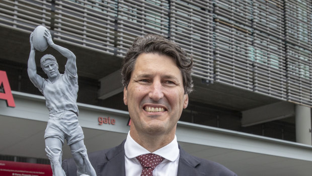 Former Queensland and Wallabies captain John Eales stands next to a model of a statue of himself at Suncorp Stadium.