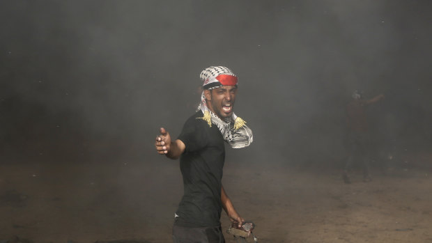 A Palestinian reacts near the fence of the Gaza Strip's border with Israel, during a protest on Friday.