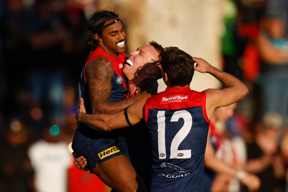 Kysaiah Pickett, James Harmes and Toby Bedford celebrate during Melbourne’s clash with Port Adelaide in Alice Springs in July. 