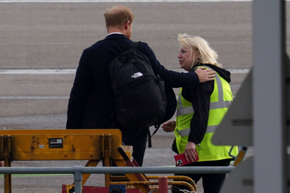 Prince Harry prepares to board a flight at Aberdeen Airport.
