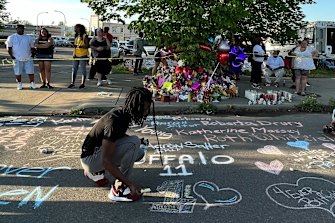Aaron chalked a memorial to the 11 black victims on the footpath near the massacre site. 