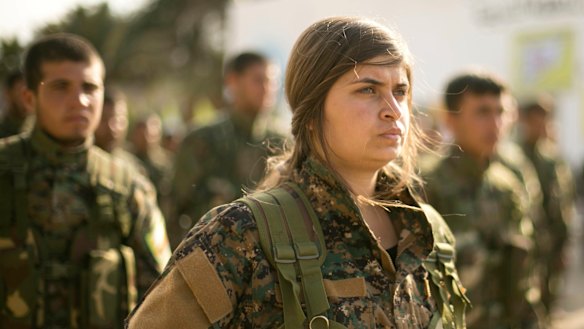 US-backed Syrian Democratic Forces stand in formation at a ceremony to mark their defeat of Islamic State militants in Baghouz.