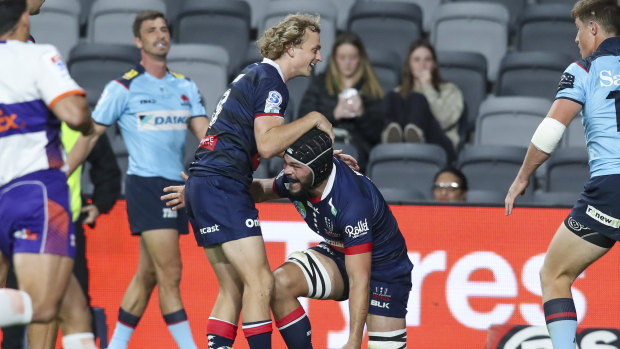 Joe Powell and Michael Wells celebrate a try against the Waratahs at Bankwest Stadium.