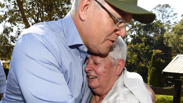 Prime Minister Scott Morrison consoles bushfire victim Pamela Skeen, who lost her home at Binna Burra in the Gold Coast hinterland.