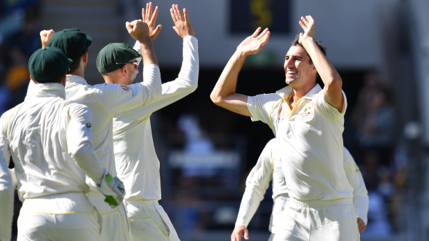 Pat Cummins (right) of Australia celebrates with team mates after getting the wicket of Lahiru Thirimanne of Sri Lanka during day three of the first Test match between Australia and Sri Lanka at the Gabba in Brisbane, on January 26, 2019. 