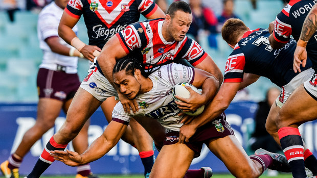 Hard fought: Manly's Martin Taupau is tackled by Boyd Cordner.