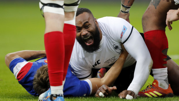 Delightful: Semi Radradra scores a try in Fiji's huge upset of the French in Paris.