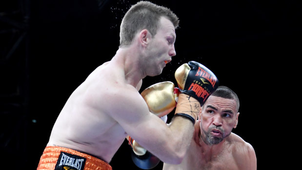 Hit and miss: Anthony Mundine lands a rare punch against Jeff Horn in Brisbane.
