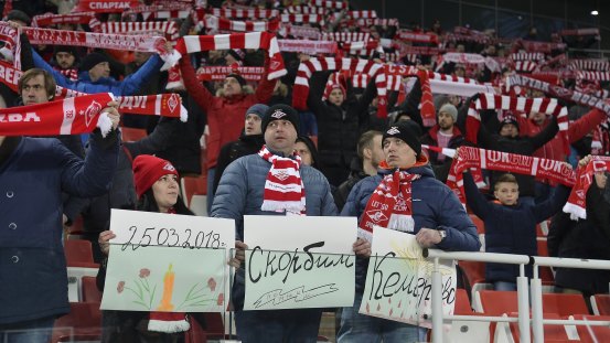 Spartak Moscow football fans hold handmade posters reading "March 25, 2018, mourn, remember, Kemerovo" during a Russian premier league game against Tosno in Moscow on Saturday.