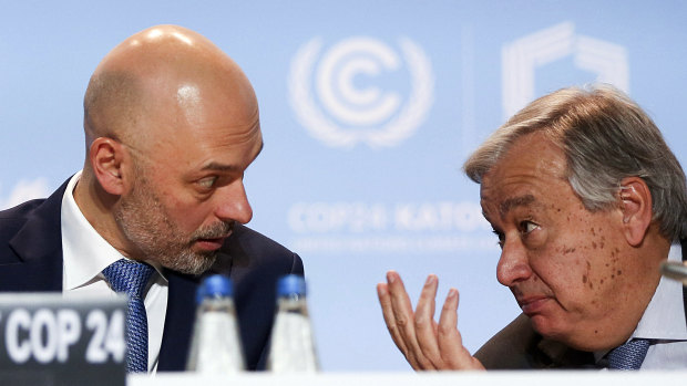 UN Secretary-General Antonio Guterres, right, talks to UN climate conference president, Poland's Deputy Environment Minister Michal Kurtyka.