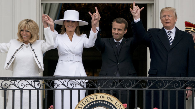 Trump and Macron, with their wives Melania Trump and Brigitte Macron, wave from the Truman Balcony during a State Arrival ceremony on the South Lawn.