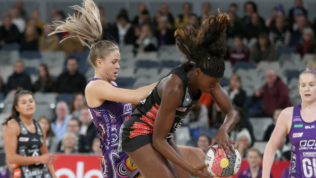 Feathers fly: Collingwood's Shimona Nelson  takes possession against Kim Jenner of the Firebirds.