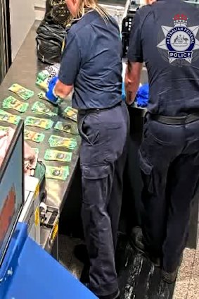 The cash being counted at Perth Airport.