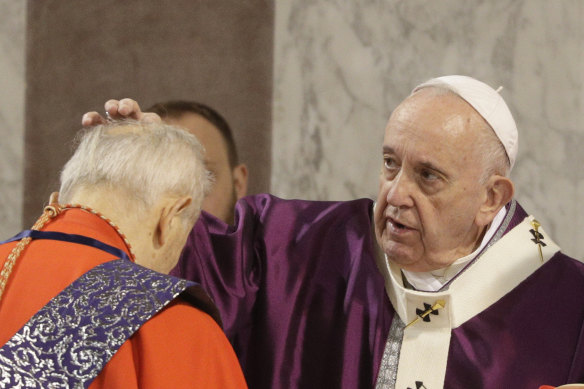 Pope Francis puts ashes on the forehead of a cardinal during a 2020  Ash Wednesday Mass marking the beginning of Lent.