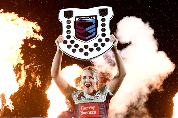 Ali Brigginshaw holds the Origin shield aloft. 