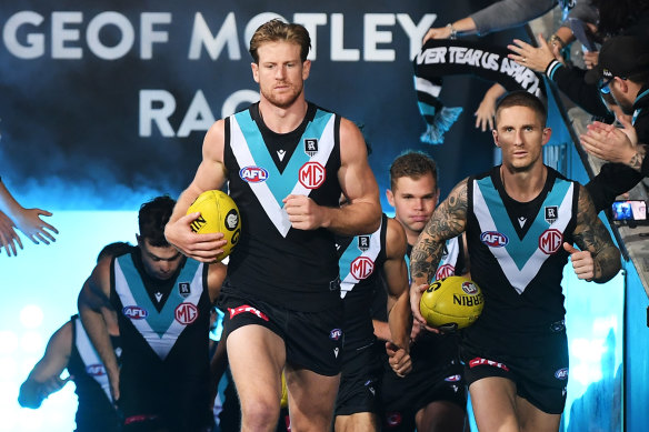 Port wore their teal, white and black jumper for the game but donned the prison bars to sing the song.