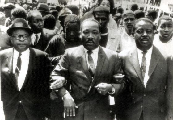 Martin Luther King jnr (centre) locks arms with Rev. Ralph Abernathy, right, and Rev. Ralph Jackson, left, during a civil rights march in Memphis in March 1968.