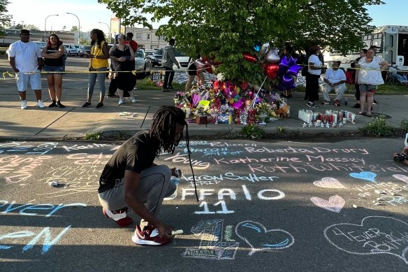 Aaron chalked a memorial to the 11 black victims on the footpath near the massacre site. 