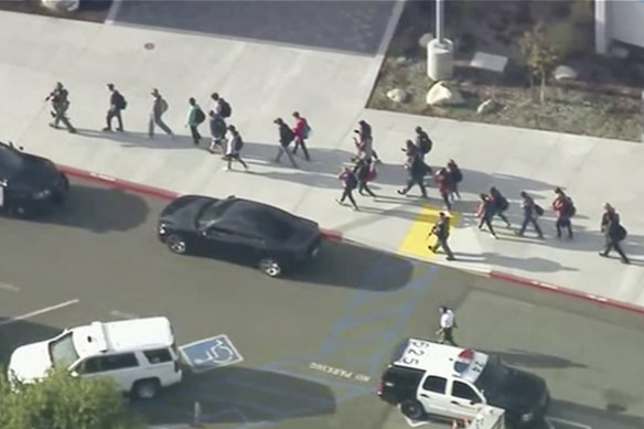 People are led out of Saugus High School in the city of Santa Clarita.