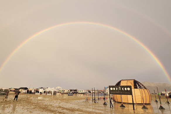 People walk through the mud at Burning Man in Black Rock City.