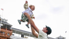 Uplifiting. Captain Pat Cummins celebrates Australia’s win in the second Test with son Albie.