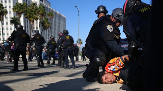A protester is arrested by California Highway Patrol near the federal building in downtown Los Angeles on Tuesday.