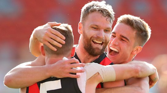 Devon Smith, Jake Stringer, and Matt Guelfi celebrate a key goal.
