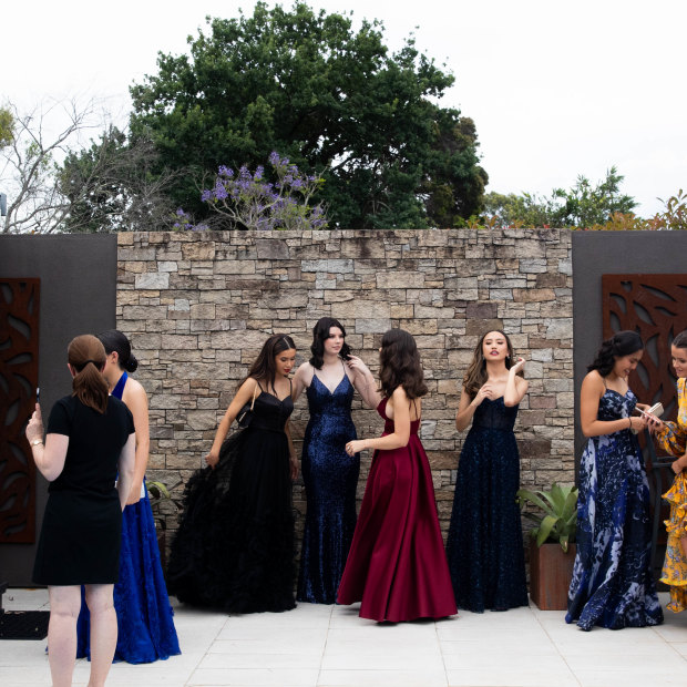 Our Lady of Mercy College Parramatta students post at a pre-formal gathering with their parents.