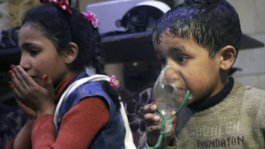 This image released early on Sunday, April 8, 2018 by the Syrian Civil Defence White Helmets, shows a child receiving oxygen through respirators following an alleged poison gas attack in the rebel-held town of Douma, near Damascus, Syria. 