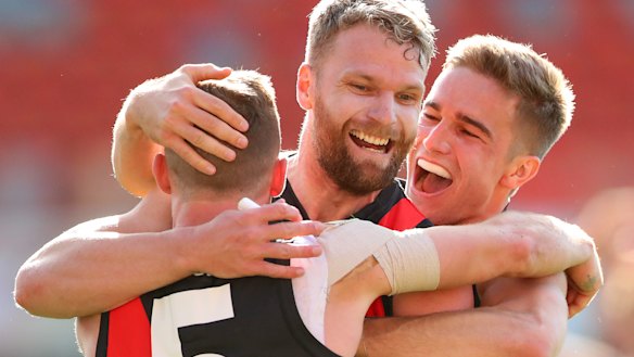 Devon Smith, Jake Stringer, and Matt Guelfi celebrate a key goal.