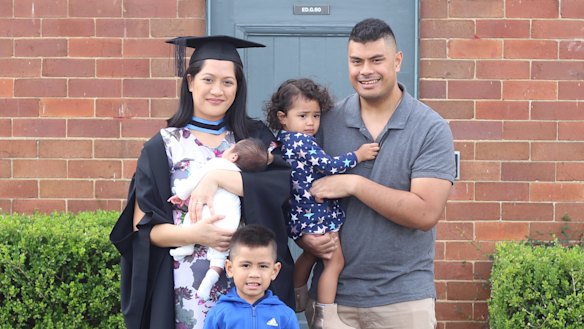 Danielle Mahe, with her husband and three children, on the day she graduated from university.