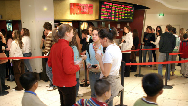 Strong chance me and my jean shorts are somewhere in this 2004 stock image of people going to the movies. 