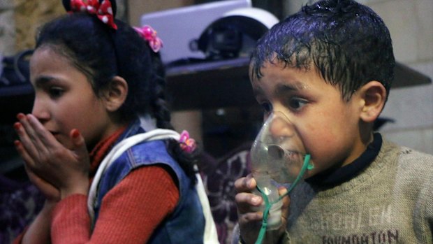 This image released early on Sunday, April 8, 2018 by the Syrian Civil Defence White Helmets, shows a child receiving oxygen through respirators following an alleged poison gas attack in the rebel-held town of Douma.