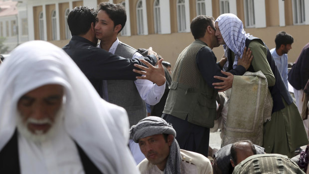 Men hug each other after Eid al-Fitr prayers outside of Shah-e-Dushamshera mosque in Kabul, Afghanistan, on Friday.