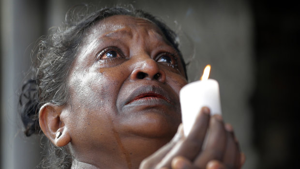 A woman prays in tears during three minutes of silence on Tuesday morning. 
