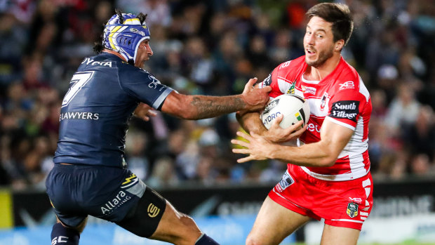 Sidestepped: Ben Hunt of the Dragons gets past Johnathan Thurston in Townsville.