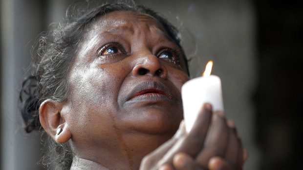 A woman prays in tears during three minutes of silence on Tuesday morning. 