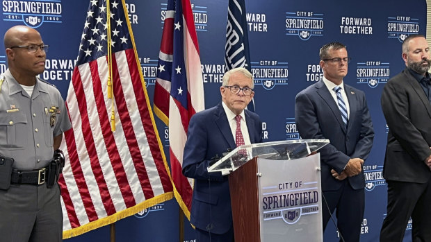 Republican Ohio Governor Mike DeWine (centre) holds a news conference in Springfield.