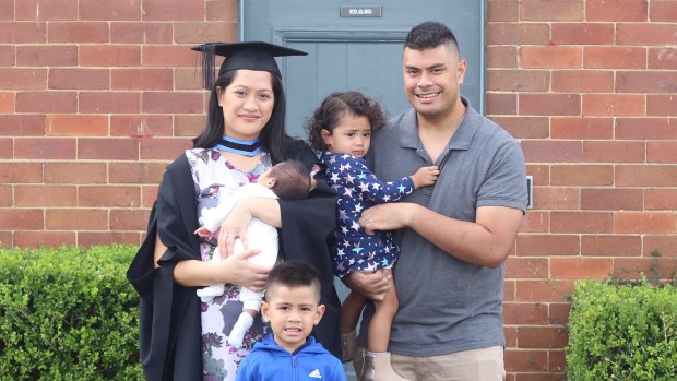 Danielle Mahe, with her husband and three children, on the day she graduated from university.