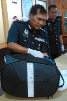 Director of Customs at Malaysia's international airport shows the bag allegedly containing drugs that was being carried by Maria Elvira Pinto Exposto when she was arrested.