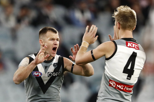 Robbie Gray celebrates a goal with Todd Marshall during Port Adelaide’s narrow win over the Magpies.