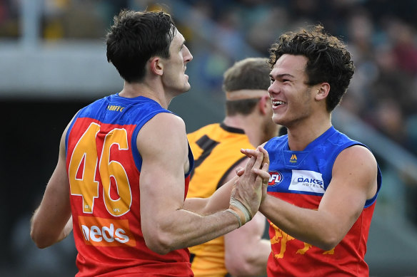 Cameron Rayner (right) and Oscar McInerney of the Lions react after McInerney kicked a goal.