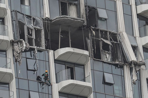 A steeplejack is seen assessing a damaged building in Dubai’s Creek Harbour after drone strikes earlier this year.