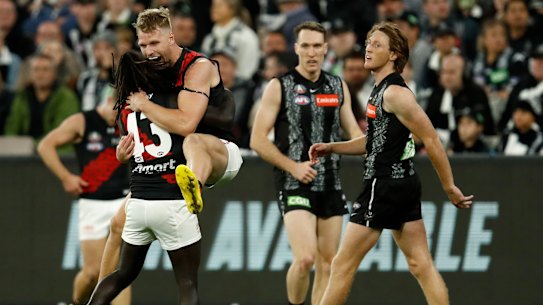 Anthony McDonald-Tipungwuti and Jake Stringer of the Bombers celebrate a key goal during their Anzac Day clash with Collingwood at the MCG.