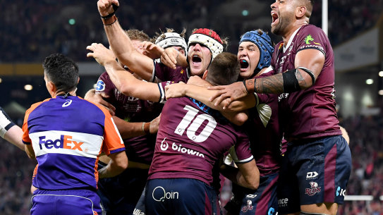 James O’Connor of the Reds is congratulated by team mates after scoring the match winning try.