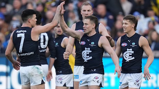 Carlton players get around Matthew Owies after his goal against Richmond.