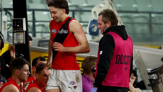 Essendon’s injury woes continued with Nic Martin hobbling from the ground.