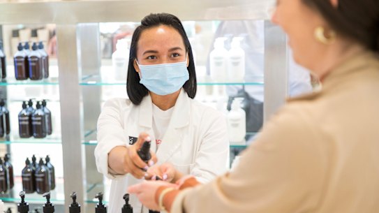 Testing times ... Okta Sampurna (left) helps a customer at the Grown Alchemist counter at David Jones, which has implemented several hygiene changes in its beauty department.