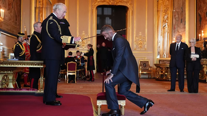 Bend a knee like Beckham: Soccer great is knighted by King Charles III