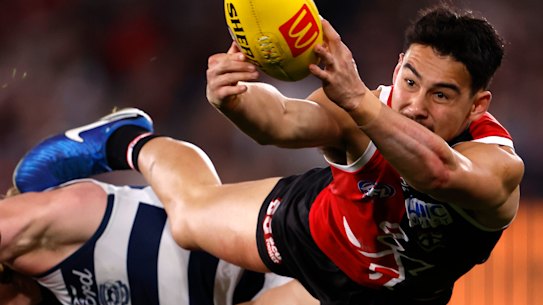 Mitch Owens of the Saints attempts to mark the ball.